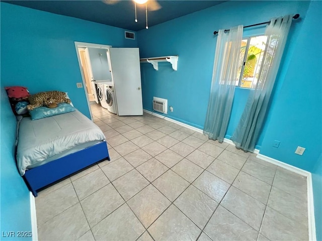 421 Courtney Ln, Las Vegas, NV 89107 - tiled bedroom featuring washer and dryer, heating unit, and ceiling fan