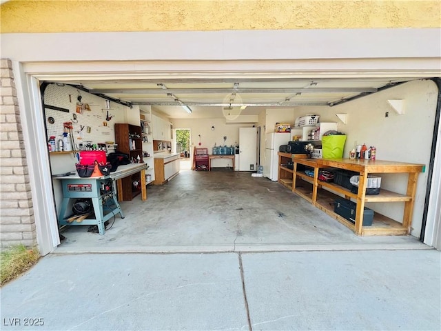 421 Courtney Ln, Las Vegas, NV 89107 - garage with a workshop area and freestanding refrigerator