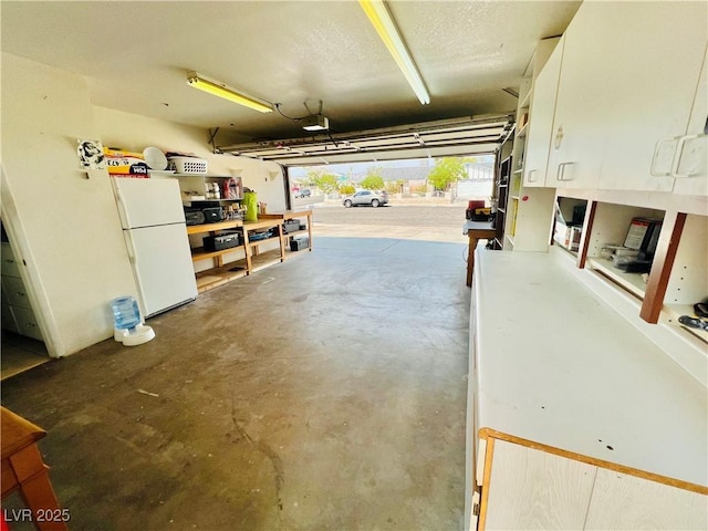 421 Courtney Ln, Las Vegas, NV 89107 - garage with freestanding refrigerator and a garage door opener