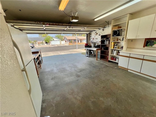 421 Courtney Ln, Las Vegas, NV 89107 - garage with freestanding refrigerator and a garage door opener