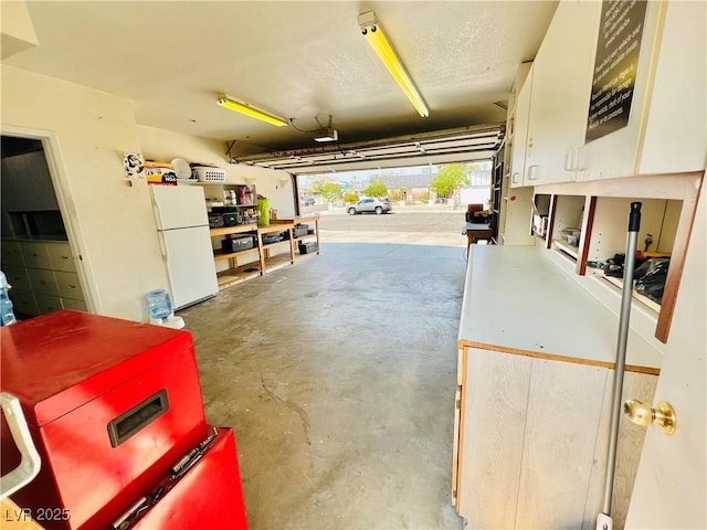 421 Courtney Ln, Las Vegas, NV 89107 - garage featuring freestanding refrigerator and a garage door opener
