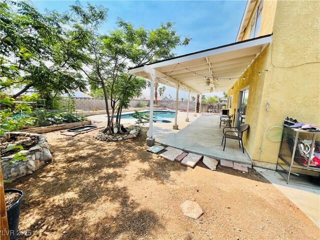 421 Courtney Ln, Las Vegas, NV 89107 - fenced backyard with a patio area and ceiling fan