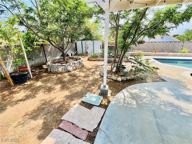 421 Courtney Ln, Las Vegas, NV 89107 - fenced backyard featuring a storage shed and a patio area