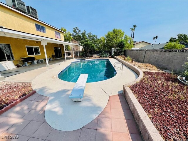 421 Courtney Ln, Las Vegas, NV 89107 - view of swimming pool with a patio, a fenced backyard, and a diving board