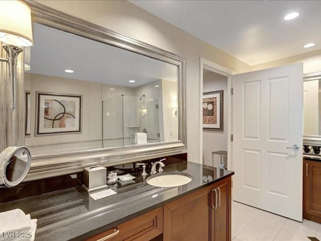 125 E Harmon Ave Unit 220, Las Vegas, NV 89109 - bathroom featuring vanity, a stall shower, tile patterned flooring, and recessed lighting