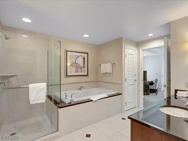 125 E Harmon Ave Unit 220, Las Vegas, NV 89109 - full bathroom featuring a stall shower, vanity, a bath, tile patterned flooring, and recessed lighting