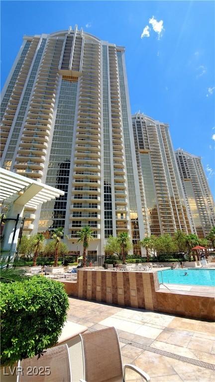 125 E Harmon Ave Unit 220, Las Vegas, NV 89109 - view of property featuring a community pool