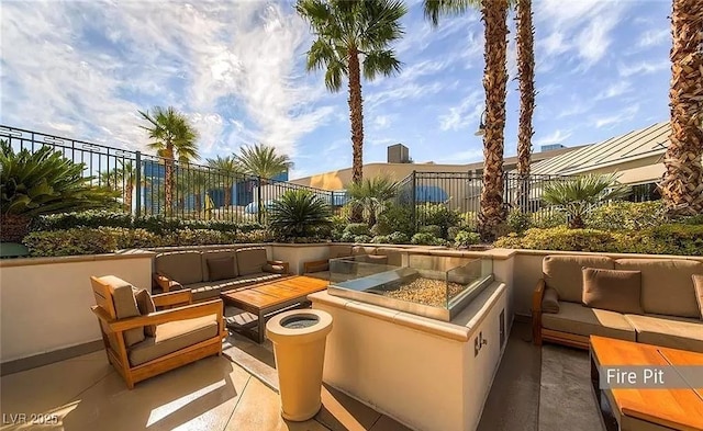 125 E Harmon Ave Unit 220, Las Vegas, NV 89109 - view of patio / terrace with an outdoor living space with a fire pit