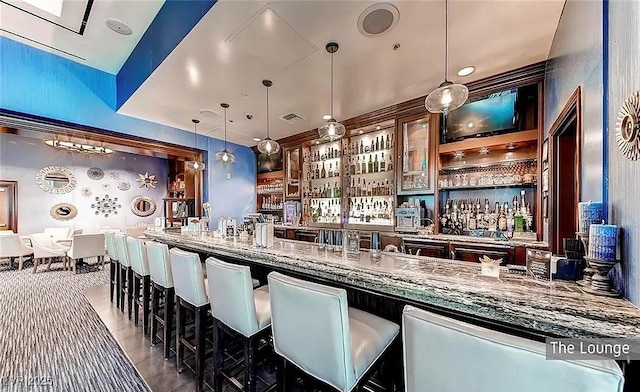 125 E Harmon Ave Unit 220, Las Vegas, NV 89109 - indoor wet bar featuring hanging light fixtures
