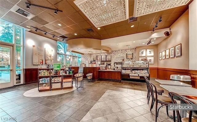 125 E Harmon Ave Unit 220, Las Vegas, NV 89109 - reception featuring a wainscoted wall, a paneled ceiling, and recessed lighting