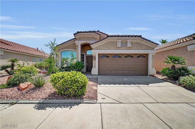 3520 Round Valley Way, Las Vegas, NV 89129 - mediterranean / spanish-style home featuring concrete driveway, an attached garage, stucco siding, and a tiled roof