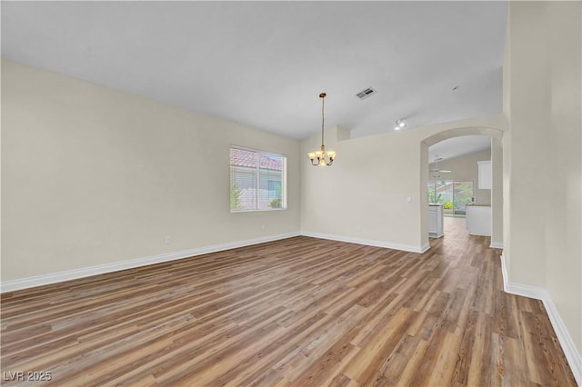 3520 Round Valley Way, Las Vegas, NV 89129 - spare room with wood finished floors, arched walkways, and a chandelier