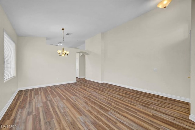 3520 Round Valley Way, Las Vegas, NV 89129 - unfurnished living room with a chandelier, arched walkways, and wood finished floors