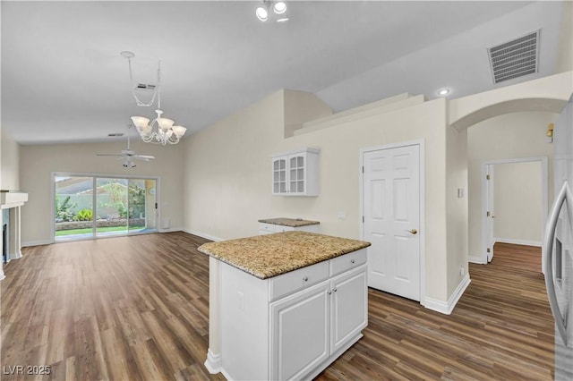 3520 Round Valley Way, Las Vegas, NV 89129 - kitchen with vaulted ceiling, arched walkways, white cabinets, dark wood-type flooring, and stainless steel refrigerator with ice dispenser