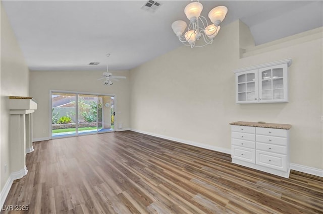3520 Round Valley Way, Las Vegas, NV 89129 - unfurnished living room featuring a chandelier, wood finished floors, vaulted ceiling, and ceiling fan