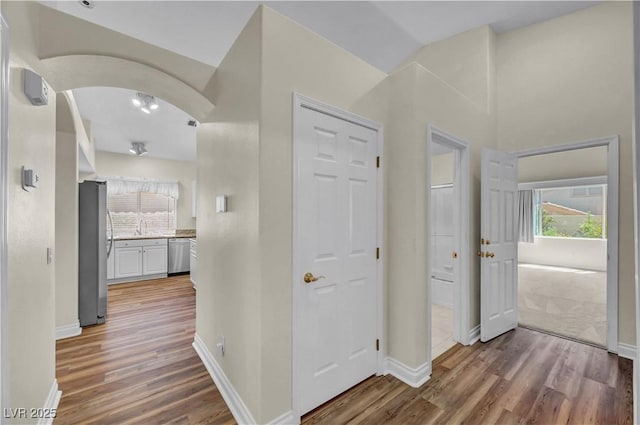 3520 Round Valley Way, Las Vegas, NV 89129 - corridor featuring light wood-style floors and arched walkways