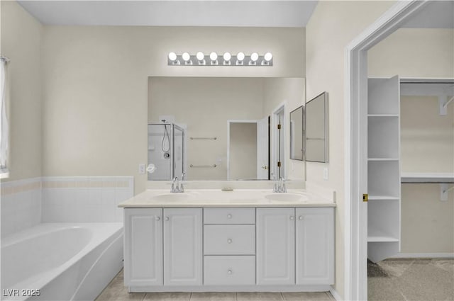 3520 Round Valley Way, Las Vegas, NV 89129 - bathroom featuring a garden tub, double vanity, an enclosed shower, and a walk in closet