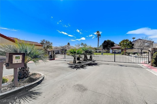 3520 Round Valley Way, Las Vegas, NV 89129 - view of asphalt street with a gate, a gated entry, and curbs