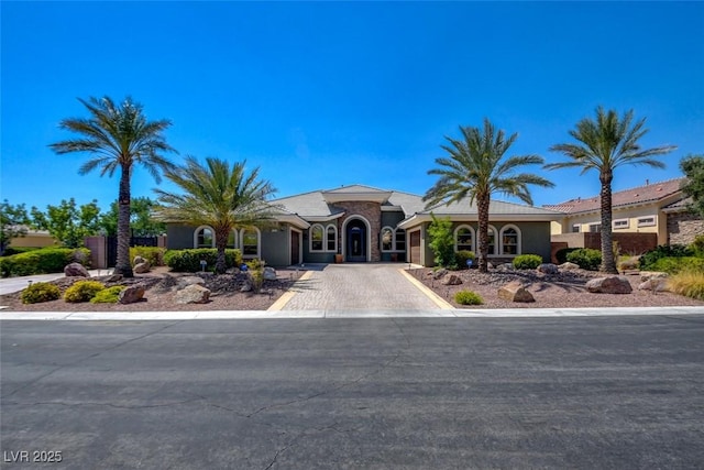 8465 Picket Ridge Ct, Las Vegas, NV 89143 - mediterranean / spanish-style home featuring driveway, an attached garage, and stucco siding