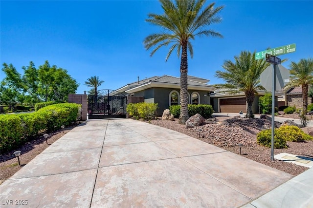 8465 Picket Ridge Ct, Las Vegas, NV 89143 - view of front of property featuring a gate, stucco siding, and driveway
