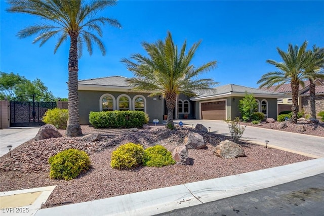 8465 Picket Ridge Ct, Las Vegas, NV 89143 - view of front of property featuring an attached garage, stucco siding, driveway, a tile roof, and a gate