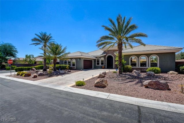 8465 Picket Ridge Ct, Las Vegas, NV 89143 - mediterranean / spanish-style home featuring an attached garage, driveway, and stucco siding