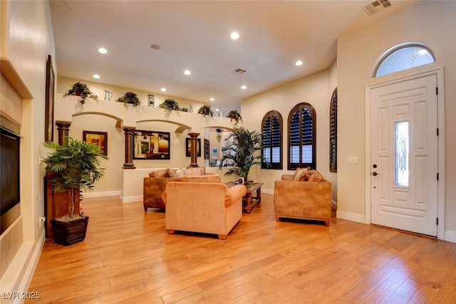 8465 Picket Ridge Ct, Las Vegas, NV 89143 - living area with light wood-type flooring, recessed lighting, and arched walkways