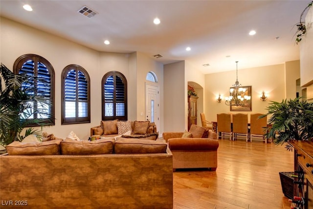 8465 Picket Ridge Ct, Las Vegas, NV 89143 - living area with light wood-style flooring, a chandelier, and recessed lighting