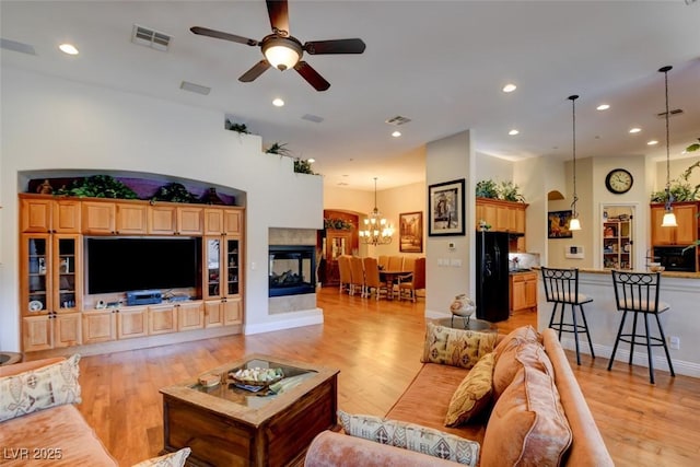 8465 Picket Ridge Ct, Las Vegas, NV 89143 - living room with light wood-style floors, a ceiling fan, a chandelier, and recessed lighting