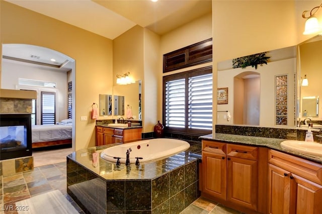 8465 Picket Ridge Ct, Las Vegas, NV 89143 - ensuite bathroom with a garden tub, healthy amount of natural light, and vanity