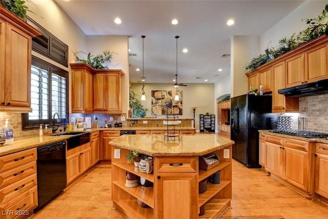 8465 Picket Ridge Ct, Las Vegas, NV 89143 - kitchen with open shelves, backsplash, light wood finished floors, an island with sink, and light stone countertops