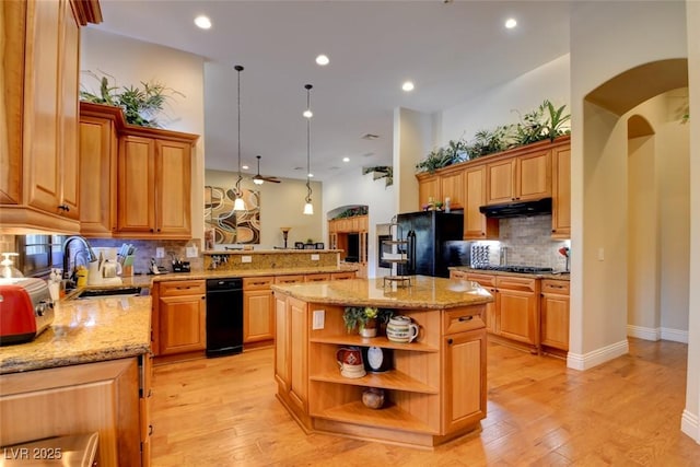 8465 Picket Ridge Ct, Las Vegas, NV 89143 - kitchen with open shelves, decorative backsplash, a peninsula, light stone countertops, and light wood-style flooring