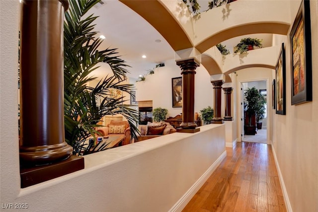 8465 Picket Ridge Ct, Las Vegas, NV 89143 - hall with decorative columns, hardwood / wood-style floors, arched walkways, and recessed lighting