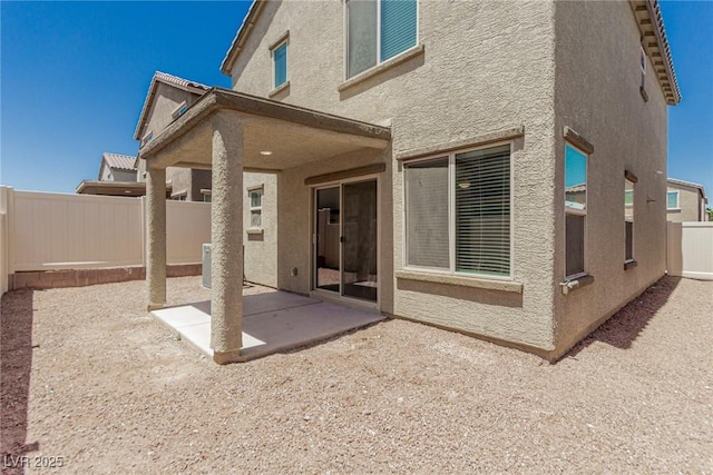 6443 Burlap Ct, Las Vegas, NV 89122 - back of property featuring a patio area, stucco siding, and a fenced backyard