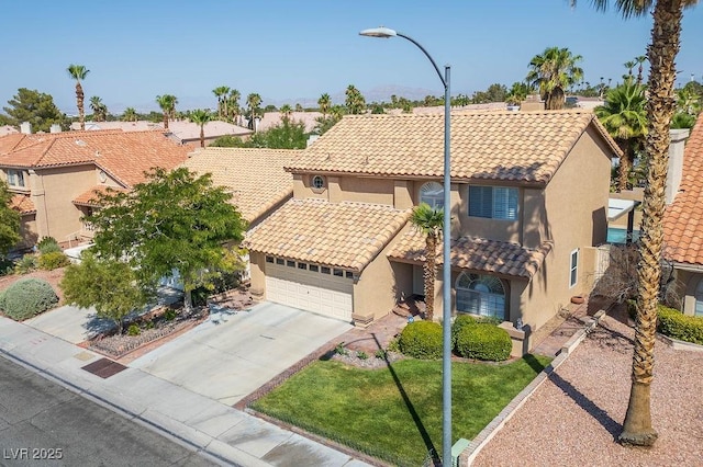 2228 Brighton Shore St, Las Vegas, NV 89128 - mediterranean / spanish home featuring stucco siding, a tiled roof, a garage, and driveway