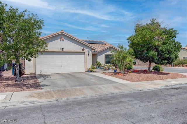 441 Groft Way, Henderson, NV 89015 - view of front facade featuring driveway, an attached garage, roof mounted solar panels, stucco siding, and a tiled roof