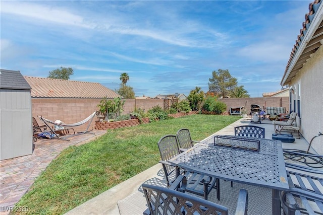 441 Groft Way, Henderson, NV 89015 - fenced backyard featuring a patio area, outdoor dining area, and a storage unit