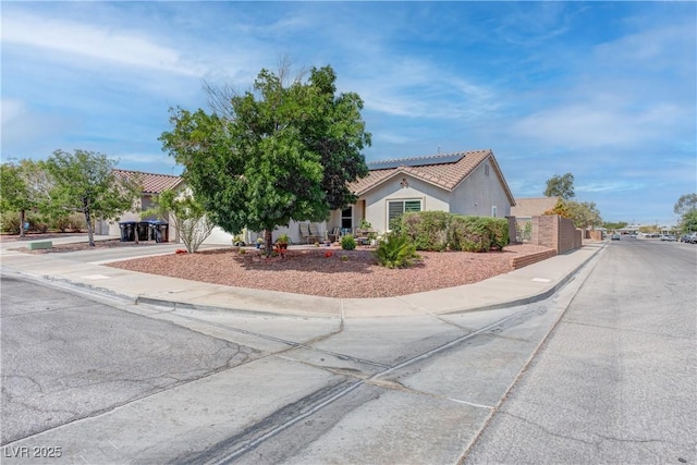 441 Groft Way, Henderson, NV 89015 - view of front of house featuring solar panels, driveway, stucco siding, a tiled roof, and a garage