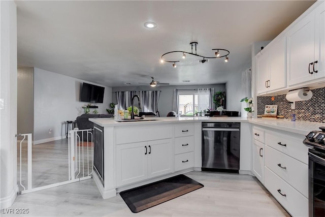 441 Groft Way, Henderson, NV 89015 - kitchen with a peninsula, dishwasher, black electric range, backsplash, and light countertops