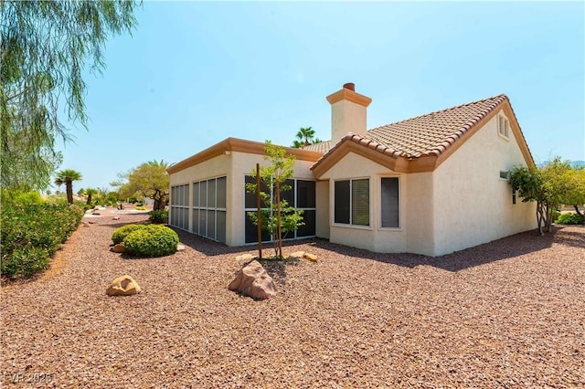 3016 Lotus Hill Dr, Las Vegas, NV 89134 - back of property featuring a chimney, stucco siding, and a tiled roof