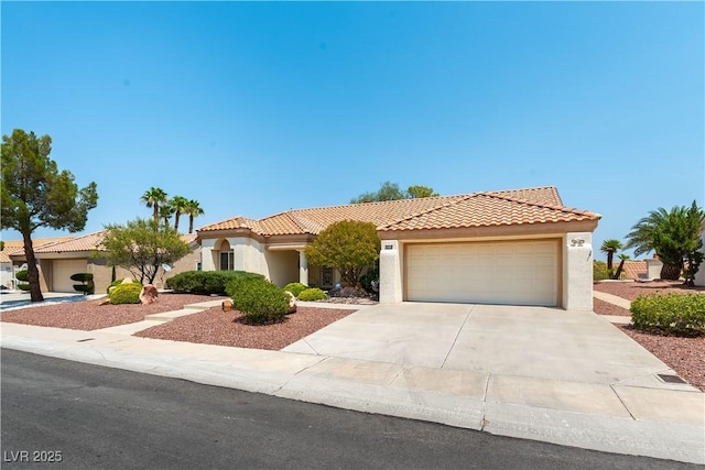 3016 Lotus Hill Dr, Las Vegas, NV 89134 - mediterranean / spanish house featuring concrete driveway, stucco siding, an attached garage, and a tiled roof