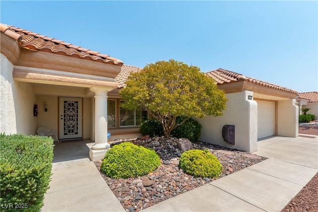 3016 Lotus Hill Dr, Las Vegas, NV 89134 - view of front of property featuring a garage, stucco siding, concrete driveway, and a tiled roof