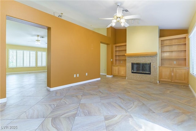3016 Lotus Hill Dr, Las Vegas, NV 89134 - unfurnished living room featuring a ceiling fan and a tile fireplace