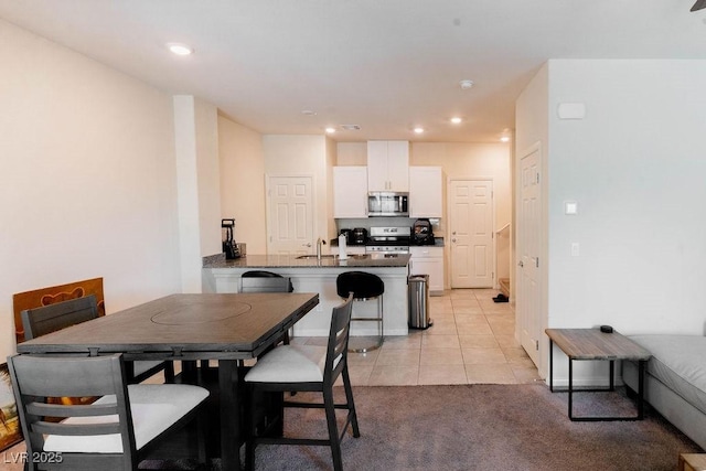 7331 Sunray Point St, North Las Vegas, NV 89084 - dining space with recessed lighting, light tile patterned flooring, and light colored carpet