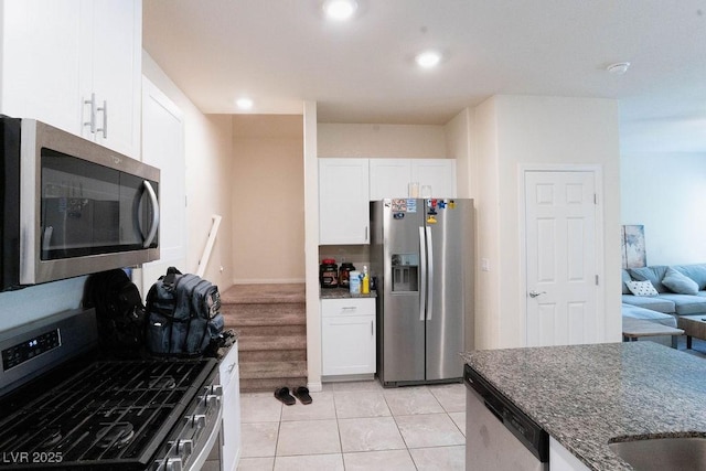 7331 Sunray Point St, North Las Vegas, NV 89084 - kitchen featuring appliances with stainless steel finishes, white cabinets, dark stone countertops, light tile patterned floors, and recessed lighting
