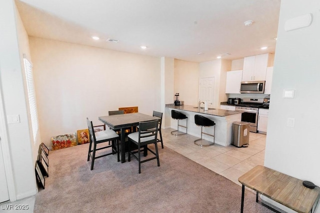 7331 Sunray Point St, North Las Vegas, NV 89084 - dining room with recessed lighting, light carpet, and light tile patterned floors