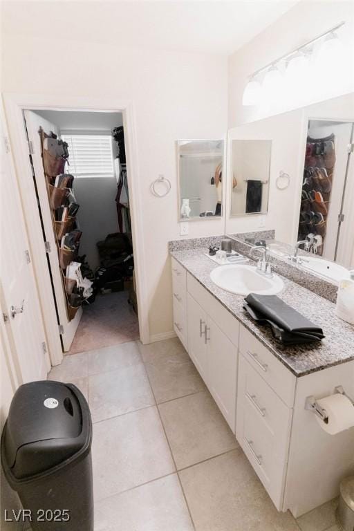 7331 Sunray Point St, North Las Vegas, NV 89084 - bathroom with tile patterned floors, vanity, and a walk in closet