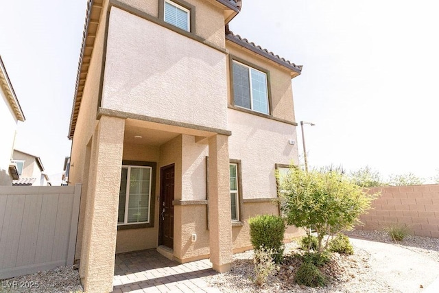 7331 Sunray Point St, North Las Vegas, NV 89084 - property entrance with stucco siding and a tile roof