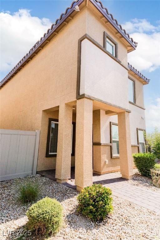 7331 Sunray Point St, North Las Vegas, NV 89084 - rear view of house featuring stucco siding and a tile roof