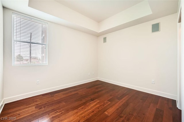 87 E Agate Ave Unit 208, Las Vegas, NV 89123 - unfurnished room with a tray ceiling and dark wood-style floors